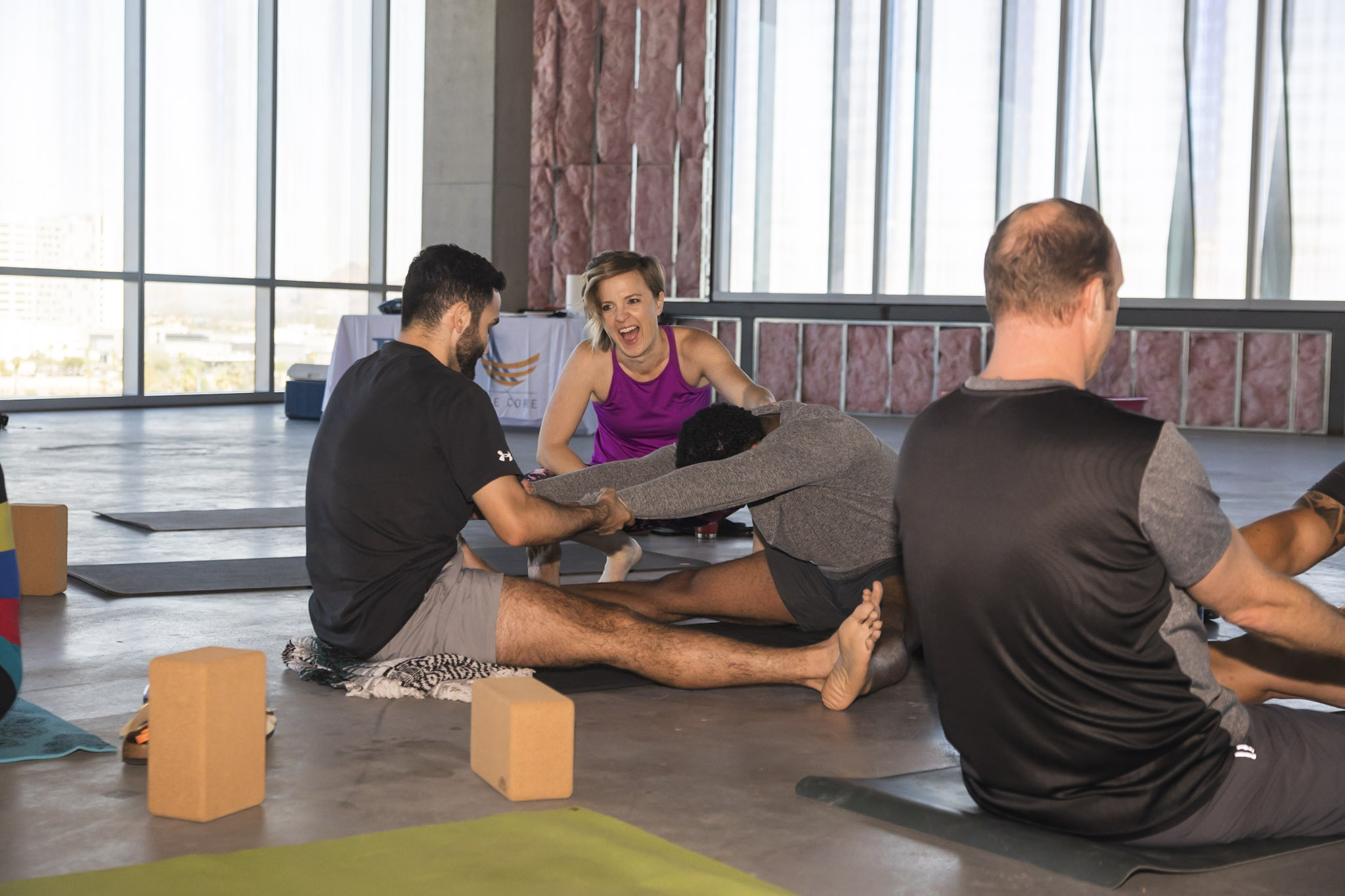 Teresa Porter guiding coworkers through a partner yoga practice