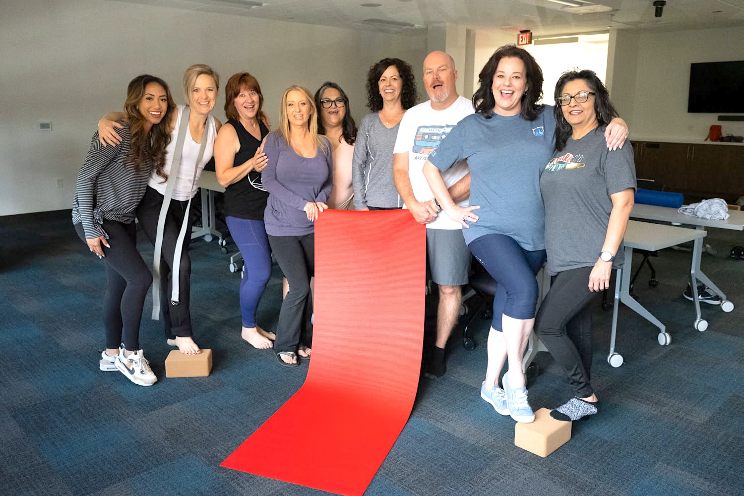 A workplace team after a Sirrine Yoga wellness session