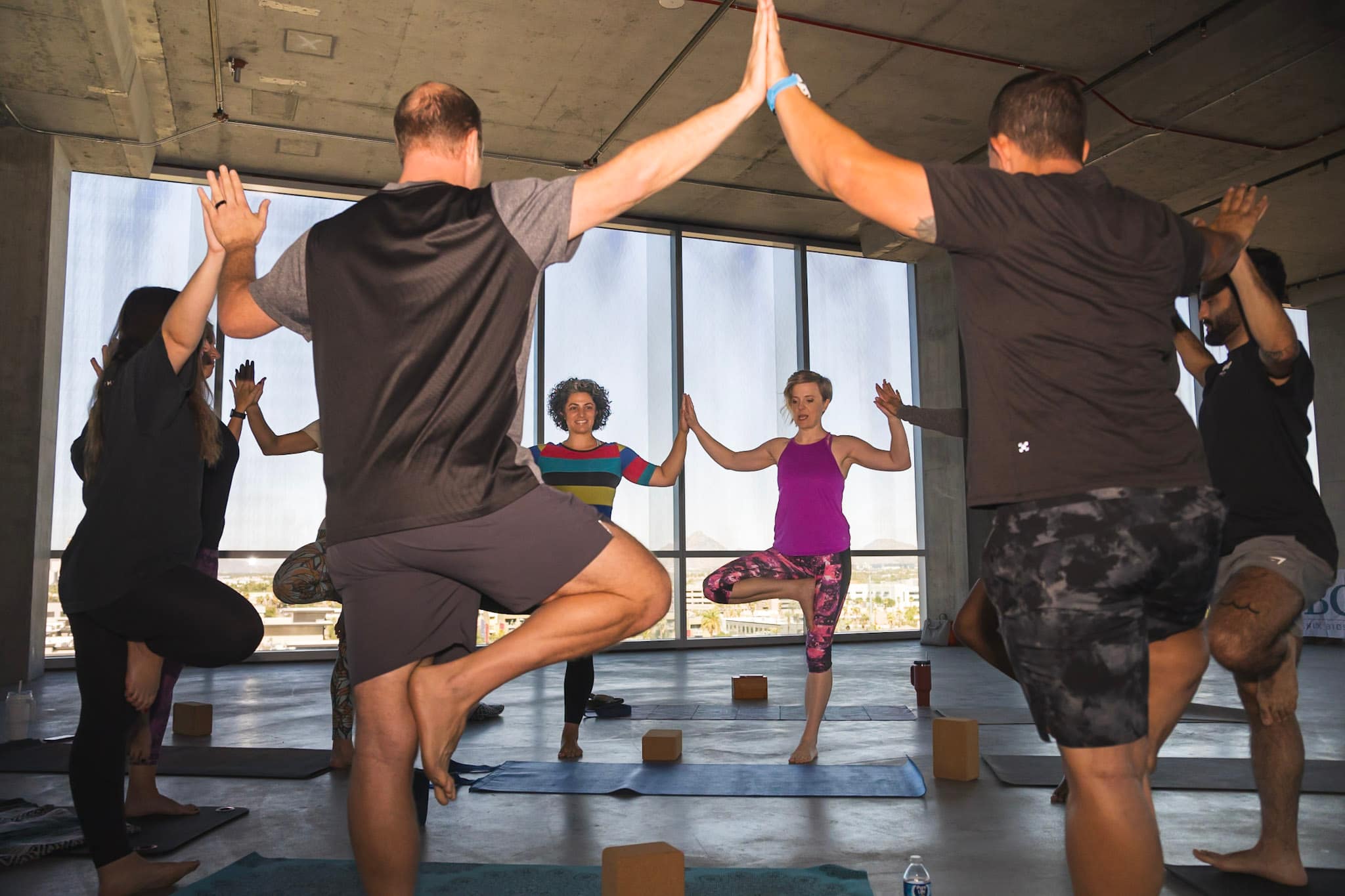 A team practicing accessible movement together during a Sirrine Yoga workplace session